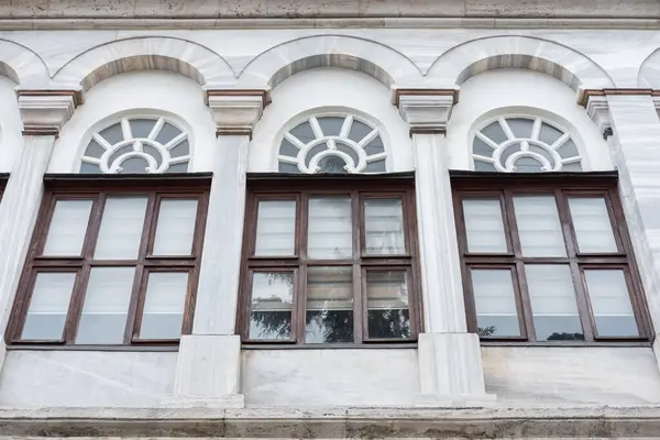 Tree windows on Vintage architecture classical facade of a historical building. Old historic architecture in Istanbul Turkey. Travel photo, nobody