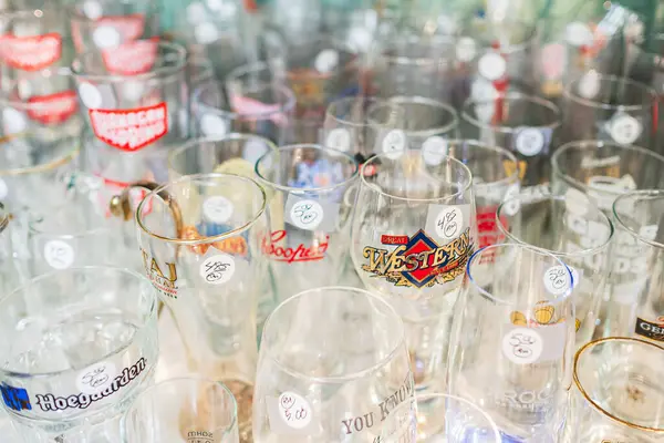 stock image Different empty beer glassware, wine glasses, glass beakers and cups on a table. A collection of elegant crystal glasses. Set of different empty glasses on sale-Vancouver Canada-October 10,2022