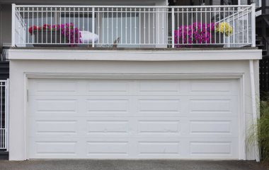 Garage Door. Modern house with white garage door that is closed. A perfect neighborhood. Family house with wide garage door and concrete driveway in front. Street photo, nobody clipart