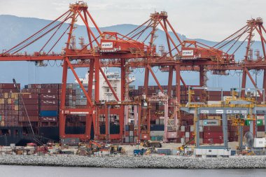 Container port terminal in Vancouver, Canada. The bustling Port of Vancouver with cargo containers being loaded and unloaded. Port of Vancouver container terminal with cranes-Aug 18,2021-Editorial clipart