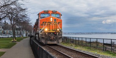 Burlington Northern Santa Fe. BNSF locomotive train passing through British Columbia White Rock. Freight Transportation Company in North America. White Rock, Canada. February 16, 2022 clipart