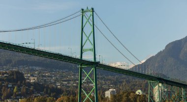 Lions Gate Bridge in summer day, Vancouver, BC, Canada. View of Lions Gate Bridge from Stanley Park. Built in the 1930s, Vancouver's Lions Gate Bridge spans across Burrard Inlet to the Northshore