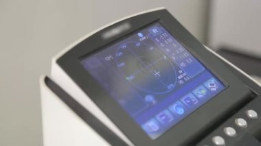Eyeglasses selection on modern diagnostic equipment in an ophthalmic clinic. Modern diagnostic equipment in ophthalmic clinic.