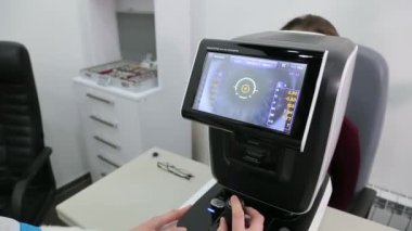 KYIV, UKRAINE - JANUARY 16, 2022: Eyeglasses selection on modern diagnostic equipment in an ophthalmic clinic. Modern diagnostic equipment in ophthalmic clinic - editorial footage