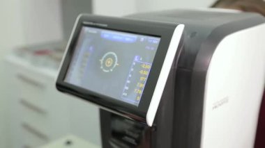 KYIV, UKRAINE - JANUARY 16, 2022: Eyeglasses selection on modern diagnostic equipment in an ophthalmic clinic. Modern diagnostic equipment in ophthalmic clinic - editorial footage