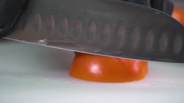 Cooking. Cutting tomatoes. Cutting a salad.