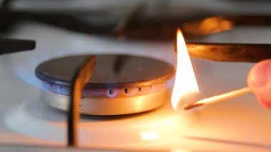 Gas burner. Lighting the gas burner with a match.