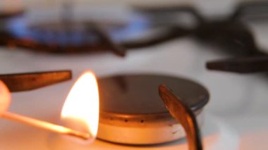 Gas burner. Lighting the gas burner with a match.