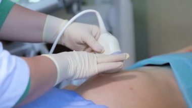 Amniocentesis. Amniotic fluid test. Ultrasound examination of the fetus of a pregnant woman. Ultrasonic scanner.