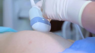 Amniocentesis. Amniotic fluid test. Ultrasound examination of the fetus of a pregnant woman. Ultrasonic scanner.