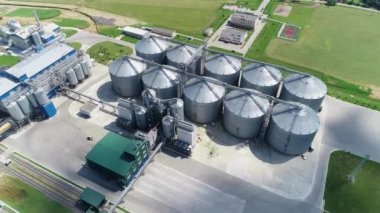 Doğada büyük bir üretim alanı. Yeşil alanların ortasındaki endüstriyel fabrikanın panoramik görüntüsü. Tahıl deposu. Hava görünümü. 