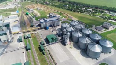 Doğada büyük bir üretim alanı. Yeşil alanların ortasındaki endüstriyel fabrikanın panoramik görüntüsü. Tahıl deposu. Hava görünümü. 
