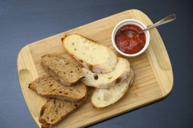 Özel soslu kızarmış siyah beyaz ekmek. Kızarmış ekmekler. Tahtada soslu çıtır tostlar..