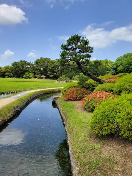 stock image OKAYAMA, JAPAN - MAY 22 2023: Visitors enjoying a leisurely walk through the beautiful Korakuen Garden, a popular tourist spot in Okayama, Japan. 