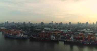 Güneş doğduğunda Bangkok Limanı 'nda konteynır gemilerinin 4k drone' u ve vinçleri kaldırıyor. 2018-07-24 Tayland.