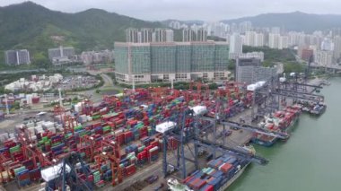 Şehir merkezindeki iş ve lojistik ürünlerini ihraç ve ithalat eden konteyner kargo gemisi. Victoria Limanı, Hong Kong 'a vinçle nakliye. Hava Görüntüleme İHA 4K görüntüsü