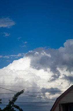 Evlerin çatılarında hafif kabarık bulutlar