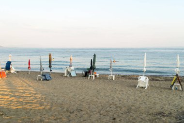 View of folded beach umbrellas on a Mediterranean beach