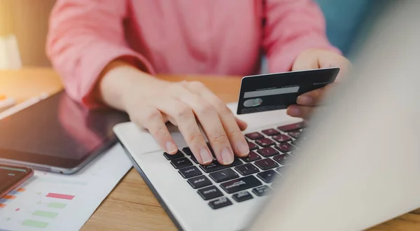 Online payment, Close-up of woman hands hold credit card and typing laptop for online shopping. Businessman, entrepreneur working, e-commerce, internet banking, spend money, working from home concept.