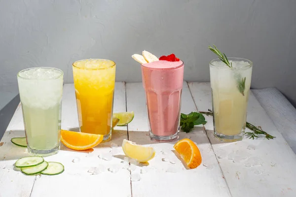 stock image Many different cocktails and milkshakes on a light background. Colored  non-alcoholic cocktails and lemonades in tall glasses