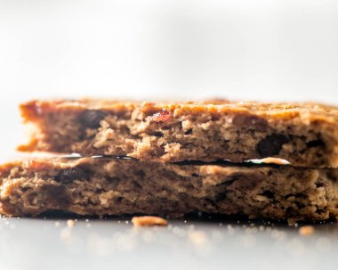 Broken brown cookie with nuts and seeds very close