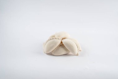Frozen semi-finished dumplings on a white background. Dumplings isolated