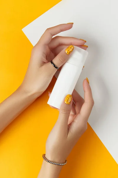 Female Hands Holding Tube Cream Lotion Orange Background Cosmetic Products — Stock Photo, Image
