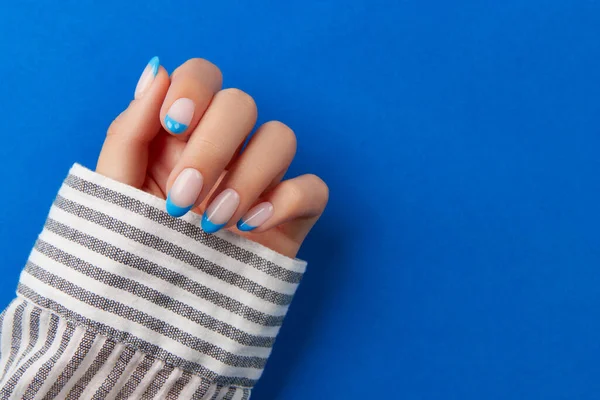 Beautiful Womans Hand Trendy Nail Design Blue Background Manicure Pedicure — стоковое фото