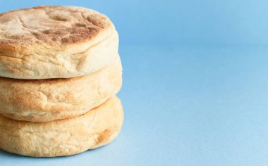 Bolo de caco. Traditional portuguese bread on blue a background. Restaurant or bakery concept clipart