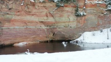Aerial view of sandstone cliffs on the banks of Ahja river located at Taevaskoja, Estonia during a cold and snowy winter day