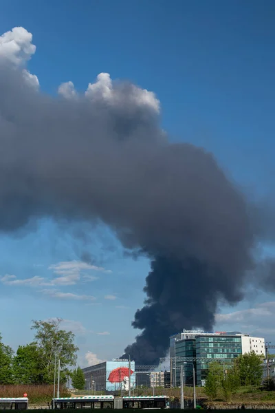 stock image Big black smoke cloud over the Tallinn city sky. Fire in the big city, natural disaster.