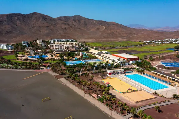 stock image Las Playitas, Spain- October 14 2021: Las Playitas Resort: A Luxurious Oasis in Canary Islands. Aerial view of resort featuring a golf course, Olympic-sized pool, and breathtaking mountain backdrop.