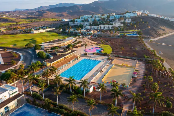 stock image Las Playitas, Spain- October 14 2021: Las Playitas Resort: A Luxurious Oasis in Canary Islands. Aerial view of resort featuring a golf course, Olympic-sized pool, and breathtaking mountain backdrop.