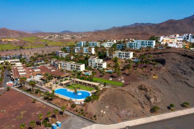 Las Playitas, Spain- October 14 2021: Las Playitas Resort: A Luxurious Oasis in Canary Islands. Aerial view of resort featuring a golf course, Olympic-sized pool, and breathtaking mountain backdrop. clipart