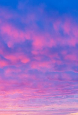 Vibrant Pink and Purple Sunrise Sky with Dreamy Cloudscape. Soft and Ethereal Morning Sky Colors Captured in a Peaceful Moment. clipart