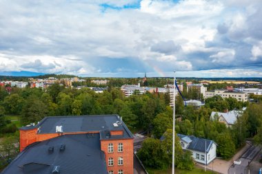 Forssa, Finlandiya - 20 Ağustos 2021: Finlandiya 'nın Forssa kentinin kırmızı tuğlalı binaları ve ağaçlarla çevrili caddeleriyle insansız hava aracı görüntüleri. Geleneksel İskandinav mimarisi ve bayrak direğine sahip şehir manzarası