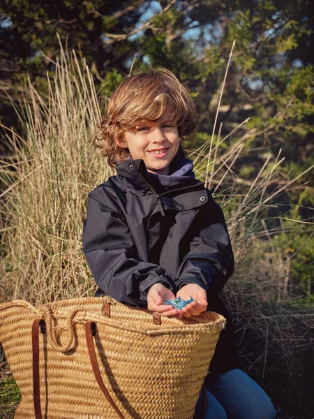 Smiling Kid Curly Blond Hair Sitting Ground Wicker Bag Holding — Stock Photo, Image