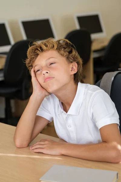 Znudzony Zmęczony Uczeń Opierający Się Dłoni Siedzący Przy Stole Klasie — Zdjęcie stockowe