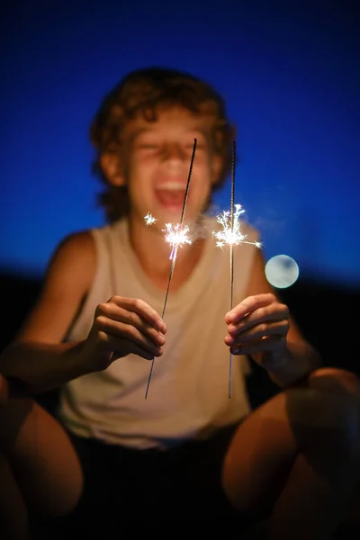 Excited Preteen Boy Looking Burning Sparklers Enjoying Celebration Holiday Background — Stock Photo, Image