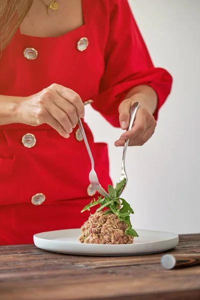 Woman Red Dress Forks Decorating Tasty Steak Tartar Fresh Herbs — Stock Photo, Image
