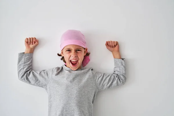 Радостный Маленький Мальчик Серой Рубашке Розовой Бандане Сжимает Кулаки Громко — стоковое фото