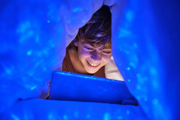 시간에 방에서 빛으로 아래누워 태블릿에서 비디오를 긍정적 — 스톡 사진