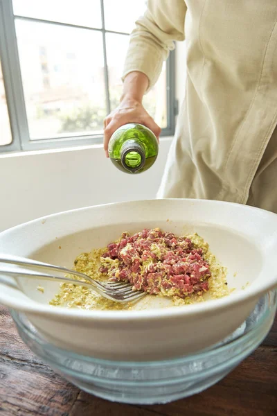 Crop Person Adding Olive Oil Dish Steak Tartare Placed Bowl — Stock Photo, Image