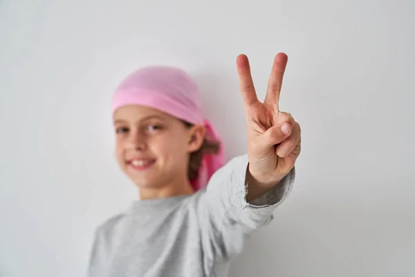 Smiling Preteen Boy Cancer Survivor Pink Bandana Showing Two Fingers — Stock Photo, Image