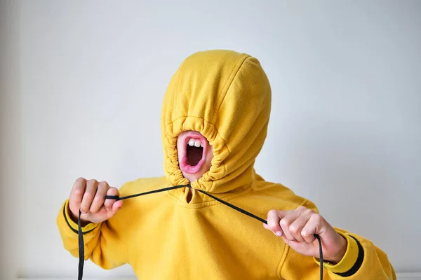 Anonymous Child Yellow Hoodie Shouting Stretching Drawstrings While Tightening Hood — Stock Photo, Image