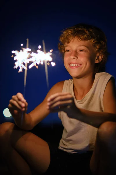 Glad Preteen Boy Holding Bright Glowing Bengal Lights While Celebrating — Stock Photo, Image