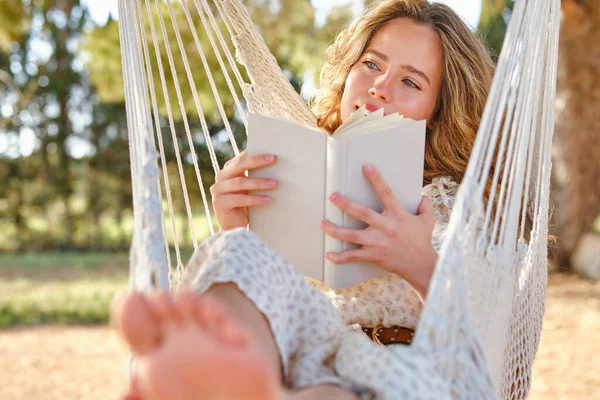 Glad Young Woman Looking Away Dreaming While Resting Hammock Reading — Stock Photo, Image