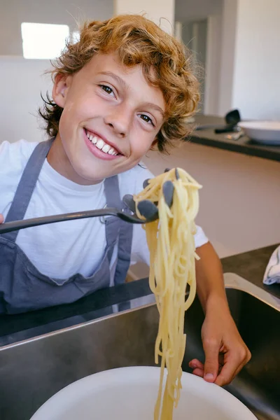 Content Child Looking Camera Cooked Pasta Spatula Sink Home Daytime — Stock Photo, Image