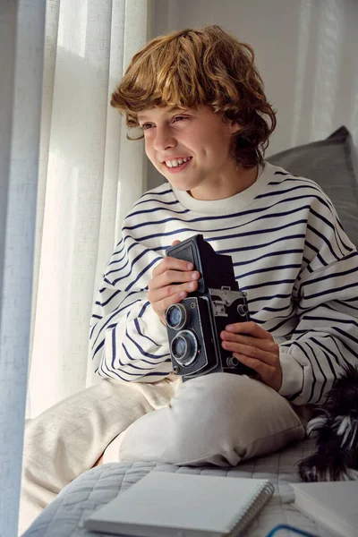 Eski Moda Fotoğraf Makinesi Olan Mutlu Çocuk Yatakta Deftere Bakmıyor — Stok fotoğraf