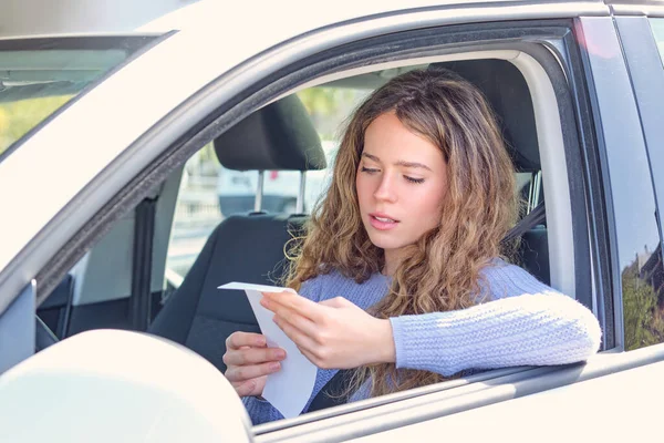 Attractive Young Female Driver Reading Penalty Receipt While Sitting Car — Stock Photo, Image